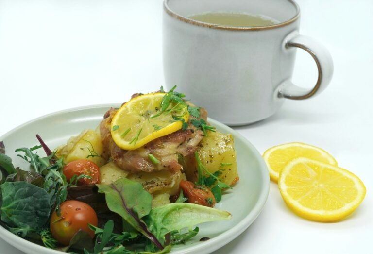 a plate of food next to a cup of tea